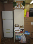 Photograph of small household shrine in a storage or office area.