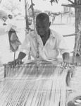 Fig03_01.  Hausa man weaving on wide-width horizontal loom in a northern Nigerian village.