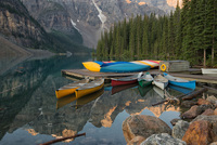 Canoes in a splash of colors await paddlers on Moraine Lake at Banff National Park in Alberta, Canada.