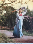 Figure 11.1. Choe outdoors posing in long sleeves dance, dressed in Korean costume with embroidered red jacket and blue skirt for the role of Kye Wŏlhyang.
