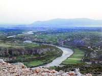 Wide shot of the Kir River Valley with Shkodër Lake, the largest freshwater lake in the Balkans, in the background.