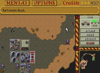 A screenshot from Dune II: The Building of a Dynasty, showing a base and a quad unit in a desertic setting.