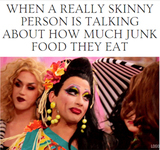 Reactiongif of a media image depicting the face of a drag queen, Bianca Del Rio, slowly blinking their eyes at another drag queen.