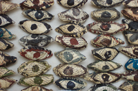 Birds-eye photo of an arrangement of paper and paint sculptures of eyes.