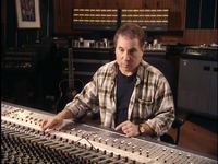 Fig. 6.1. Paul Simon sitting at a mixing board in a recording studio, manipulating the controls and listening intently.