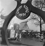 Black and white photograph, 1965 New York World’s Fair, Chun King Inn pylon, three girls checking out menu