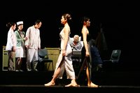 Opening scene of A Dream Like a Dream, cast circling the audience, which is in the circular center pit of Theatre Above, Shanghai, sitting on swiveling chairs.