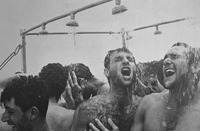 Close up black and white photo of the smiling faces of 6 IDF soldiers becoming racially homogenized by showering together in the desert.