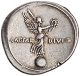 Photograph of a denarius of Octavian. Reverse: Victoria standing on a globe holding a palm and wreath.