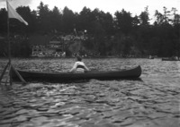 A woman races in a solo open canoe class in 1922 at a regatta in Chemong Park just north of Peterborough.