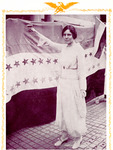 Paul stands toasting a Woman’s Party banner flag. She wears a long, white dress. The words “Jailed for Freedom” are at the top; below are the words for the first Equal Rights Amendment.