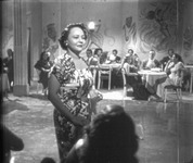 A black and white photograph of Toña la Negra in sequined gown in Amor de la calle.