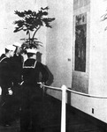 Black and white photograph, de Young Museum, three U.S. Navy sailors view a hanging Chinese landscape painting