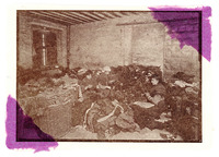 Three women sit on the floor in a dismal, dark room surrounded by heaps of rags, some piled on the floor and others in baskets. They seem to blend in among the rags piled around them.