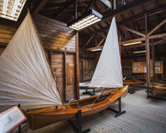 An all-wood decked sailing canoe with a double sail rig on display at the Antique Boat Museum in Clayton, New York.