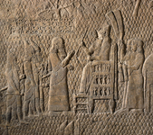 Relief depicting a figure seated and facing four other figures. Behind the seated figure are two others, fanning them.