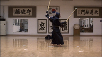 Bushido partners duel in front of a number of banners on the wall with black calligraphy.