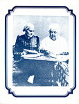 The two collaborators sit at a desk, Anthony looking at a book and Stanton writing on a sheet of paper. Both have white hair and full-length dresses; Anthony wears spectacles.