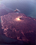 A color photograph depicting the extent of the oil spill in the water.