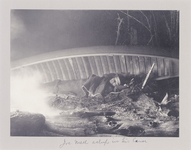 Joe Mell, a Passamaquoddy Indian, sleeps under his canoe on Duck Lake, Maine, ca. 1895.
