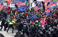 Trump supporters clashing with police and security forces as the crowd pushes barricades to storm the U.S. Capitol in Washington, D.C. on January 6, 2021. Dozens of protesters are waving large American and Trump 2020 flags and banners. The crowd of Trump supporters is pushing over iron security gates as helmeted security personnel and police, many wearing bulletproof vests, try in vain to hold the crowd at bay. Demonstrators breeched security and entered the Capitol as Congress debated the 2020 presidential election Electoral Vote Certification.