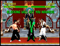 Reptile stands between both fighters, with onscreen caption “Blocking Will Get You Nowhere”