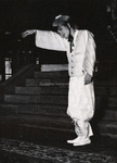 Figure 5.1. In front of stairs in a theatre, Park Yeong-in stands alone in traditional Korean male costume. He stretches out his right arm with his wrist and fingers drooping down.