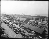Trucks and horse-­drawn wagons picked up and delivered goods at warehouses and piers along West Street in Manhattan.