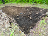 Photograph of dirt with an outline of where tumulus 088 would take place at level 5.