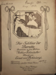 Cover of the 1910 piano score for Pierrette’s Veil, with an illustration of the dead Pierrot draped on a chair in the foreground and the aghast Pierrette looking at him in the background, both of them in white.