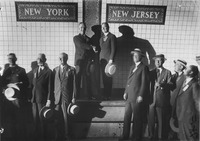The officials met in the center of the Holland Tunnel at the border between the two states.