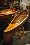 A cedar strip all-wood canoe (right) at the Canadian Canoe Museum. A “double-cedar” canoe, with a layer of canvas between the planking, is at the left.
