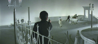 Long shot of the white Club Alulu set, with three gangsters poised in the foreground, extreme background Left, and background Right, respectively, waiting to shoot Tetsu in the center back of the shot, as he throws his gun away, then leaps back onto it and shoots in three directions before his enemies can squeeze off a shot.