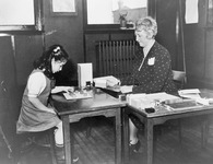 Fig. 12. A photograph recording the mental aptitude testing of a young girl in 1943.