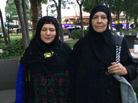 A portrait of two Iraqi women with black head scarves.