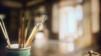 Brushes stored in a typical desktop jar.