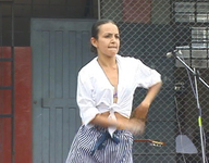 An film still showing Cynthia Paniagua in Soy Andina taking her final exam in practice of Afro-­Peruvian dance in Lima.