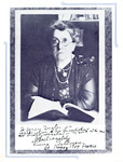 Goldman sits, crossed arms resting on a desk, with an open book. She wears round spectacles, her wavy hair is pulled back, and she looks to the viewer. Inscribed to Agnes Ingles. See Resources for more.