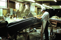 A worker at Old Town Canoes puts the finishing touches on a fiberglass model.