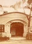 A photograph of the Loïe Fuller Theater. Atop the entrance stands a life-­sized statue of Fuller in her long, draping costume that inspired the wave-­like facade fully encompassing the building.