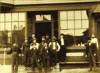 Ella and Bert Morris (far right) and his brother Charlie (far left) pose with their staff in front of the B. N. Morris storefront, ca. 1900.