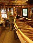 Tom Seavey attaching the extended outwale to the canvassed Veazie canoe.