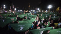 Fig. 10. A crowd of rotesters holds green scarves stretched in the air.