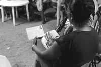 Photograph of a Codespa member holding her registration papers during a meeting.