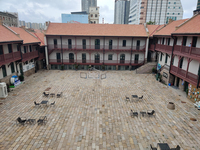 Photo showing a large, cleared-out courtyard, viewed from above.