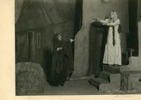 Black-and-white photograph of two actors portraying a beggar and a possessed woman.