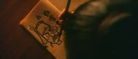 protagonist draws a childish picture of his teacher. Writes som characters next to it. Says "white cloud"