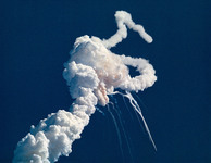 Fig. 6. Enormous white smoke trails across a clear blue sky indicate the breakup of the Space Shuttle Challenger.