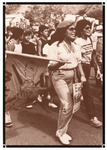 One of few peaceful demonstrations in the strike. Two women in the foreground carry signs and flags. Boys follow behind, some with fists in the air.