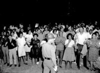 African Americans sing protest songs and clap their hands on the lawn of the Executive Mansion in Raleigh, NC, 1963.